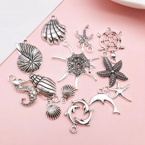 Macro shot of 12 silver sea animal charms including starfish and seahorse for DIY jewelry