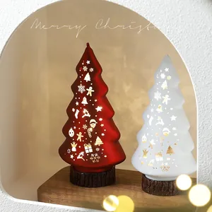 Lighted glass Christmas tree table decor with gold snowflake patterns on a wooden base