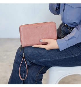 Pink vintage oil wax leather long wallet with RFID protection and wristlet strap detail