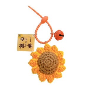 Handmade crochet sunflower keychain with vibrant orange bell and 'The first prize' lucky tag