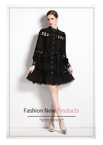 Detail of black lace dress featuring hollow-out embroidery, long sleeves, and matching belt
