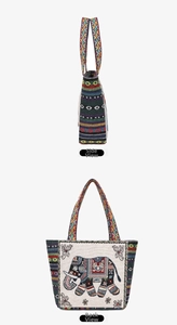 Detail view of ethnic elephant embroidery and colorful geometric woven straps on canvas tote