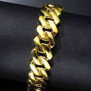 Polished gold Cuban link bracelet for men with high-shine metallic finish on black leather