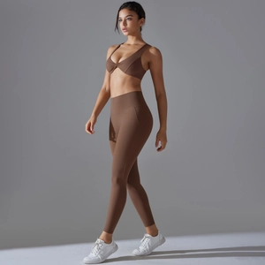 Side view of flexible cocoa brown two-piece yoga set with twist-front sports bra and leggings