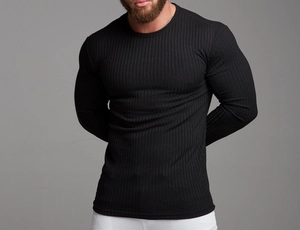 Close-up of black ribbed knit fabric and stitching on a muscle-fit long sleeve T-shirt