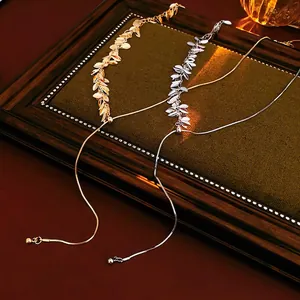 Elegant gold and silver metallic leaf sequin tassel necklaces on a snake chain