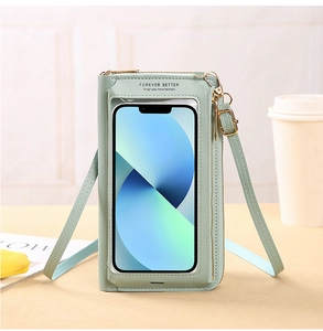 Touchscreen crossbody phone bag in pale green faux leather with clear window and strap