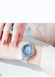Detail of blue sunray dial watch with sparkling rhinestones and date display