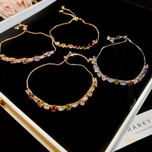 Adjustable bracelets with colorful zircon stones displayed in a black velvet jewelry box