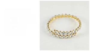 Detail of 18K gold plated spiral stainless steel bangle with square zircon settings