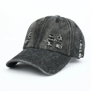 Detail view of vintage washed black denim baseball cap with distressed ripped design