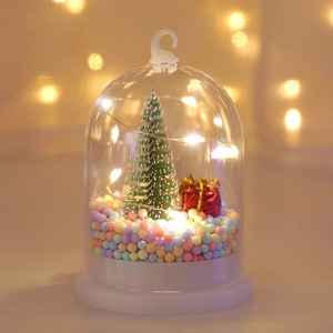 Detail of a Christmas glowing ornament with mini tree, gift box, and warm LED lights