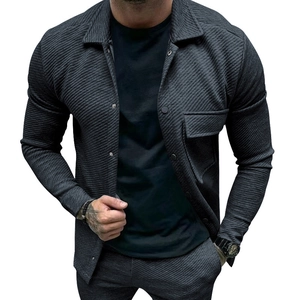 Detailed close-up of dark grey heavy twill fabric and flap pocket on a slim casual jacket