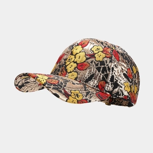 Close-up of vintage jacquard baseball cap with gold floral embroidery and curved brim