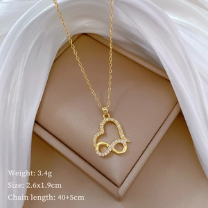 Detailed view of infinity heart gold pendant with rhinestones on silk jewelry box