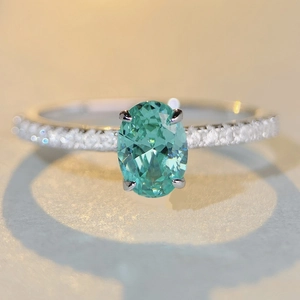 S925 sterling silver ring with oval green paraiba gemstone and pavé set diamonds
