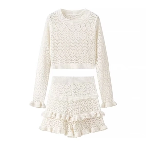 Women's cream knit set with long sleeve crop top and high waist ruffled shorts