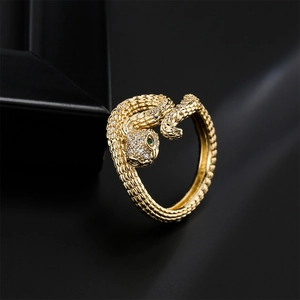 Bohemian gold snake ring with white zircon pave setting and green gemstone eyes