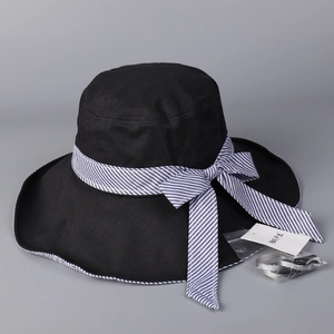 Detail of black sun hat with blue striped bow and included adjustable wind cord