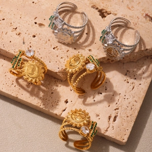 Bohemian sun face and green zircon cactus open rings set on stone background