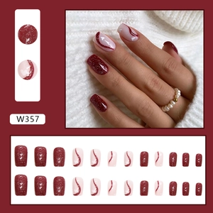Detailed view of burgundy glitter and swirl heart patterned press-on nails set W357