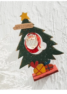 Close-up of wooden Christmas tree decor with Santa Claus detail and Welcome sign