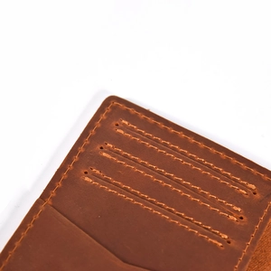 Close-up of brown crazy horse leather wallet showing high-quality stitching and texture