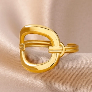 Macro detail of 18k gold plated open ring featuring a geometric D-shaped hollow design