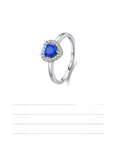 Detailed view of 925 sterling silver ring with blue heart opal and tiny inset diamonds