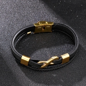 Detailed view of men's braided leather bracelet with golden infinity symbol buckle