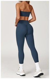 Rear view of navy blue high-waisted yoga leggings and sports bra set for women