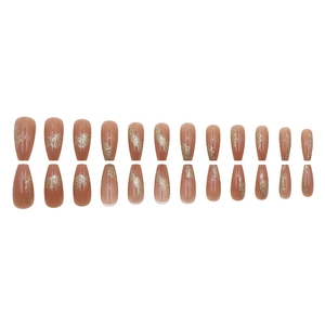 Long coffin-style press-on nails in nude amber with elegant gold foil art accents