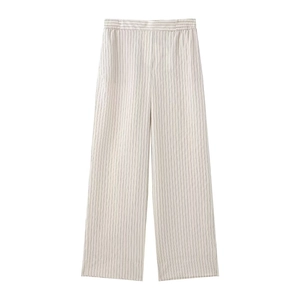 Detail of high-waist striped wide-leg trousers with elastic waistband and soft fabric texture