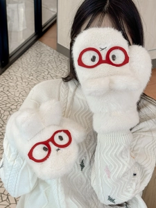 Detail of cute white plush mittens with red glasses embroidery and warm lining