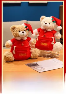 Detailed view of plush Christmas bears in red outfits with Merry Christmas embroidery