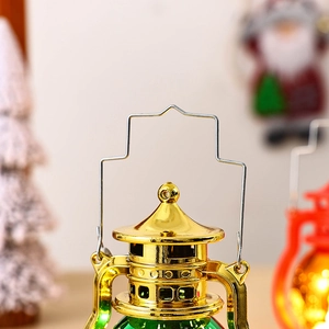 Detail shot of golden metal cap and wire handle on a green LED Christmas lantern
