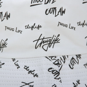 Detailed close-up of white cotton bucket hat with black graffiti print and stitching
