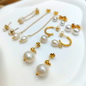 Detail showing freshwater pearl earrings set with 14K gold plated stainless steel finish