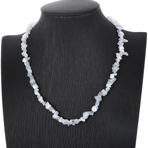 Detail view of white irregular cat eye stone necklace on a black jewelry neck mannequin