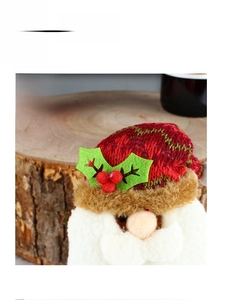 Close-up of Santa plush decor with red knitted hat and white faux beard detail