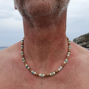 Close-up of coconut shell and tiger eye stone beads on a beach vacation style necklace