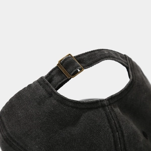 Detail of vintage washed cotton baseball cap with adjustable antique bronze metal buckle