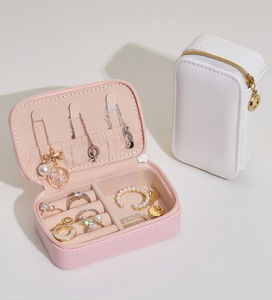 Open pink and closed white portable PU leather jewelry box showing interior compartments