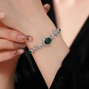 Vintage silver bracelet with oval emerald green stone and white zircon floral accents