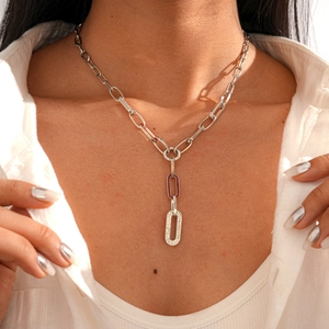 Macro detail of silver paperclip chain necklace with sparkling zircon pavé links