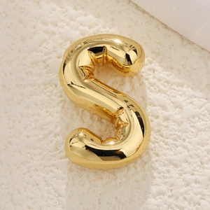 Detailed close-up of a 3D bubble style golden letter S pendant with a mirror polish finish