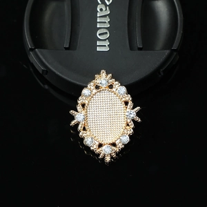Macro view of gold rhombus alloy base with clear rhinestones and mesh texture