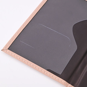 Close-up of light brown PU leather passport holder with precise stitching and transparent slot
