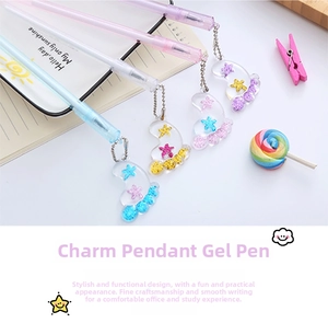 Close-up of cute pastel gel pens with glitter filled star and paw charms on a notebook