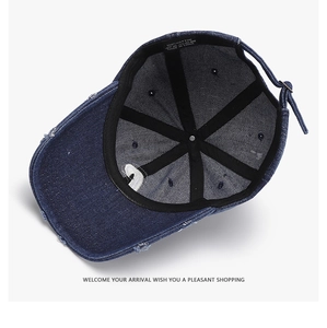 Detail view of cotton baseball cap interior with stitching and distressed denim texture